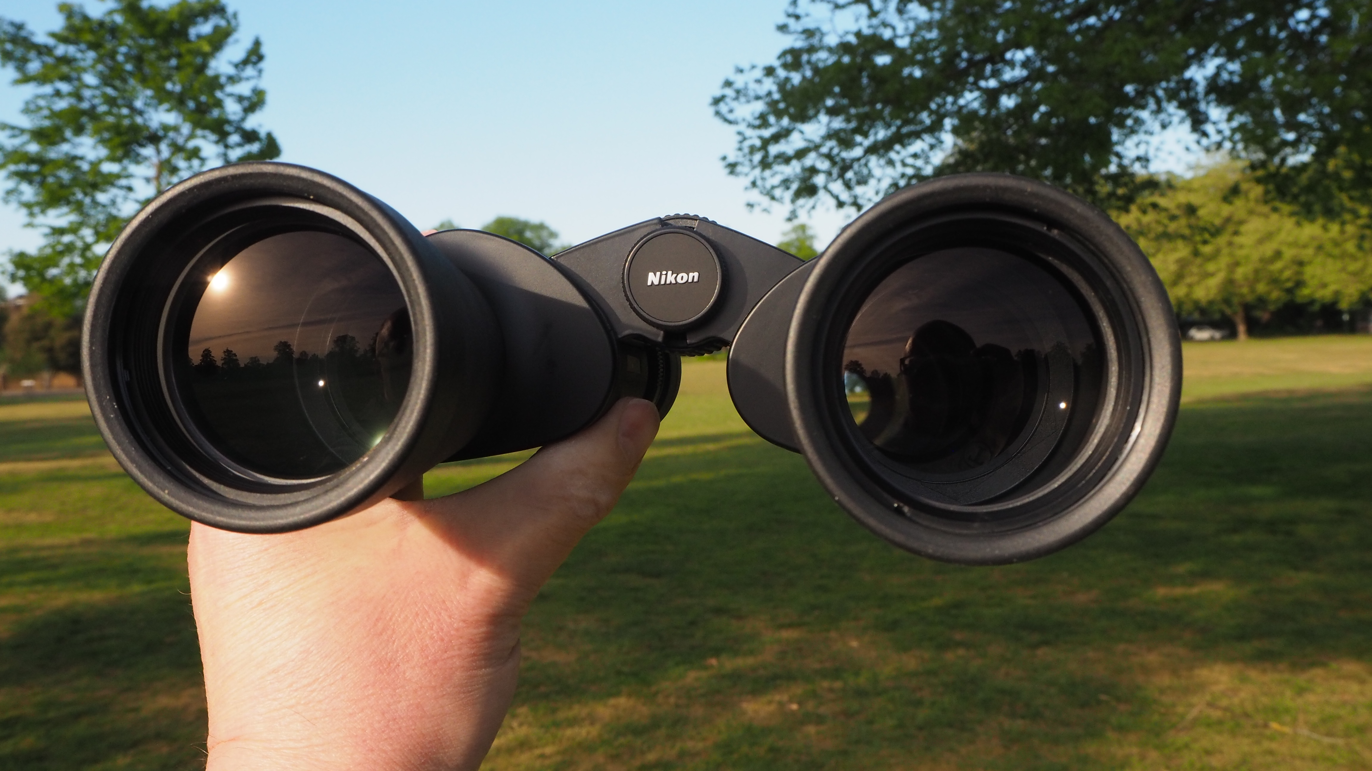Nikon Action Zoom 10-22x50 binoculars in a person's hands