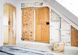 Wardrobe in a loft bedroom made from reclaimed doors