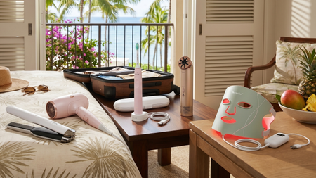 A collection of portable health and wellness devices in a hotel room in a tropical location