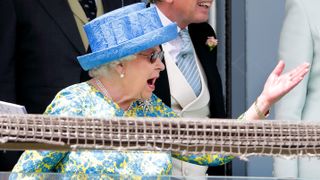 Queen Elizabeth II watches the racing as she attends 'Derby Day' of the Investec Derby Festival
