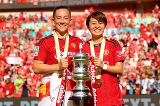 Maya Le Tissier and Hinata Miyazawa of Manchester United celebrate with the FA Cup trophy after winning the Adobe Women's FA Cup Final match between Manchester United and Tottenham Hotspur at Wembley Stadium on May 12, 2024 in London, England.