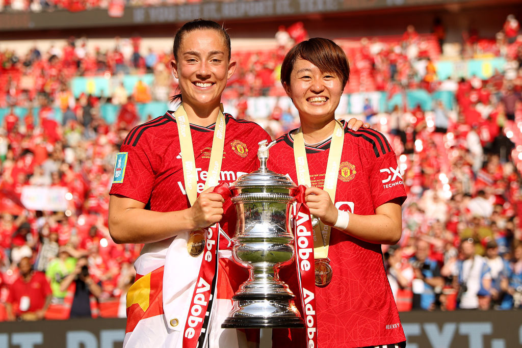 Maya Le Tissier and Hinata Miyazawa of Manchester United celebrate with the FA Cup trophy after winning the Adobe Women's FA Cup Final match between Manchester United and Tottenham Hotspur at Wembley Stadium on May 12, 2024 in London, England.