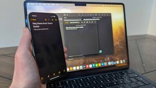iPhone 16 showing Notes app with MacBook Air 13-inch M3 in background showing Notes app to show Universal Keyboad feature