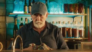 Roy Palmer (Gerard Horan) cleans a glass in Death in Paradise season 14 episode 6