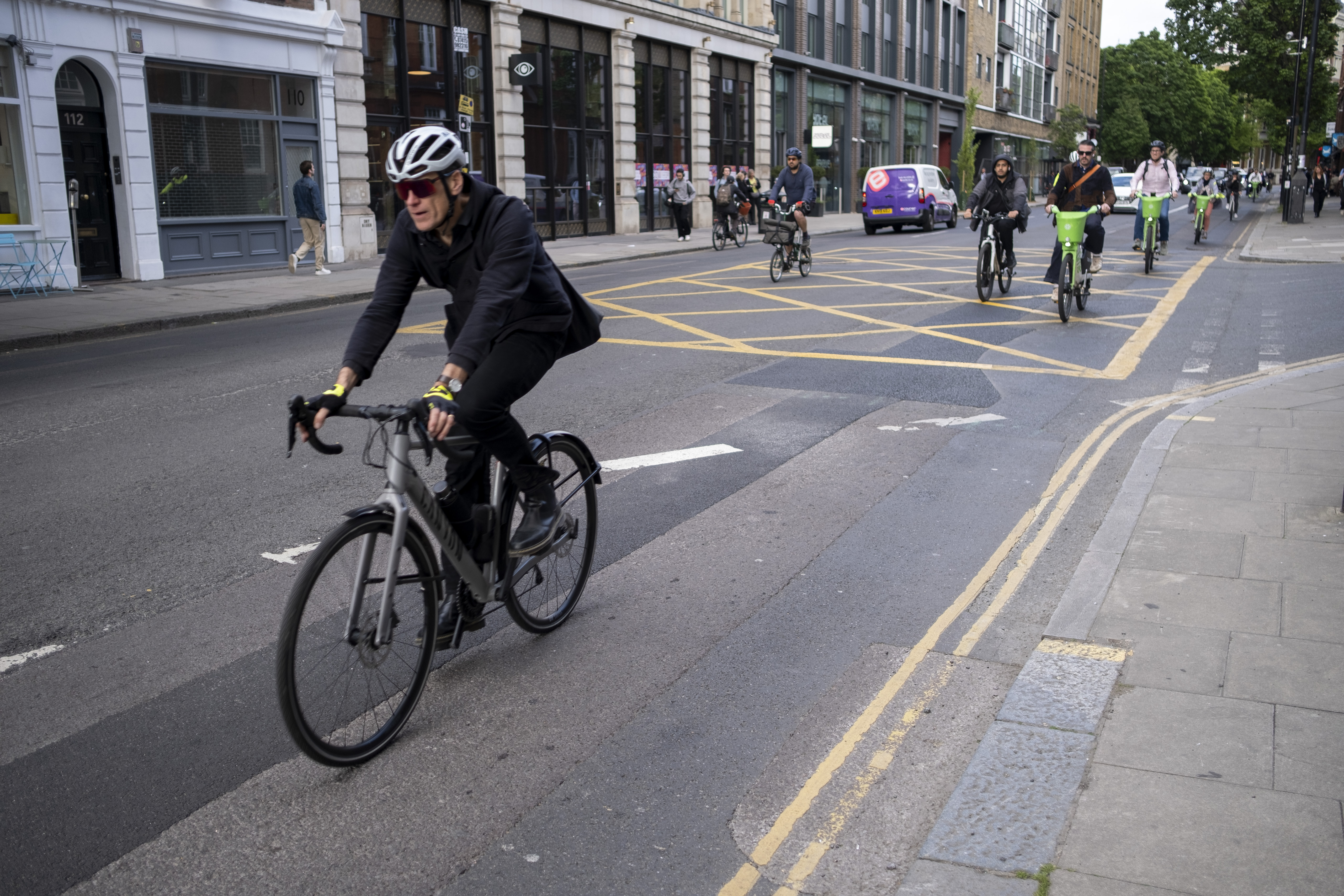 A cyclist commuting in London wearing a suit