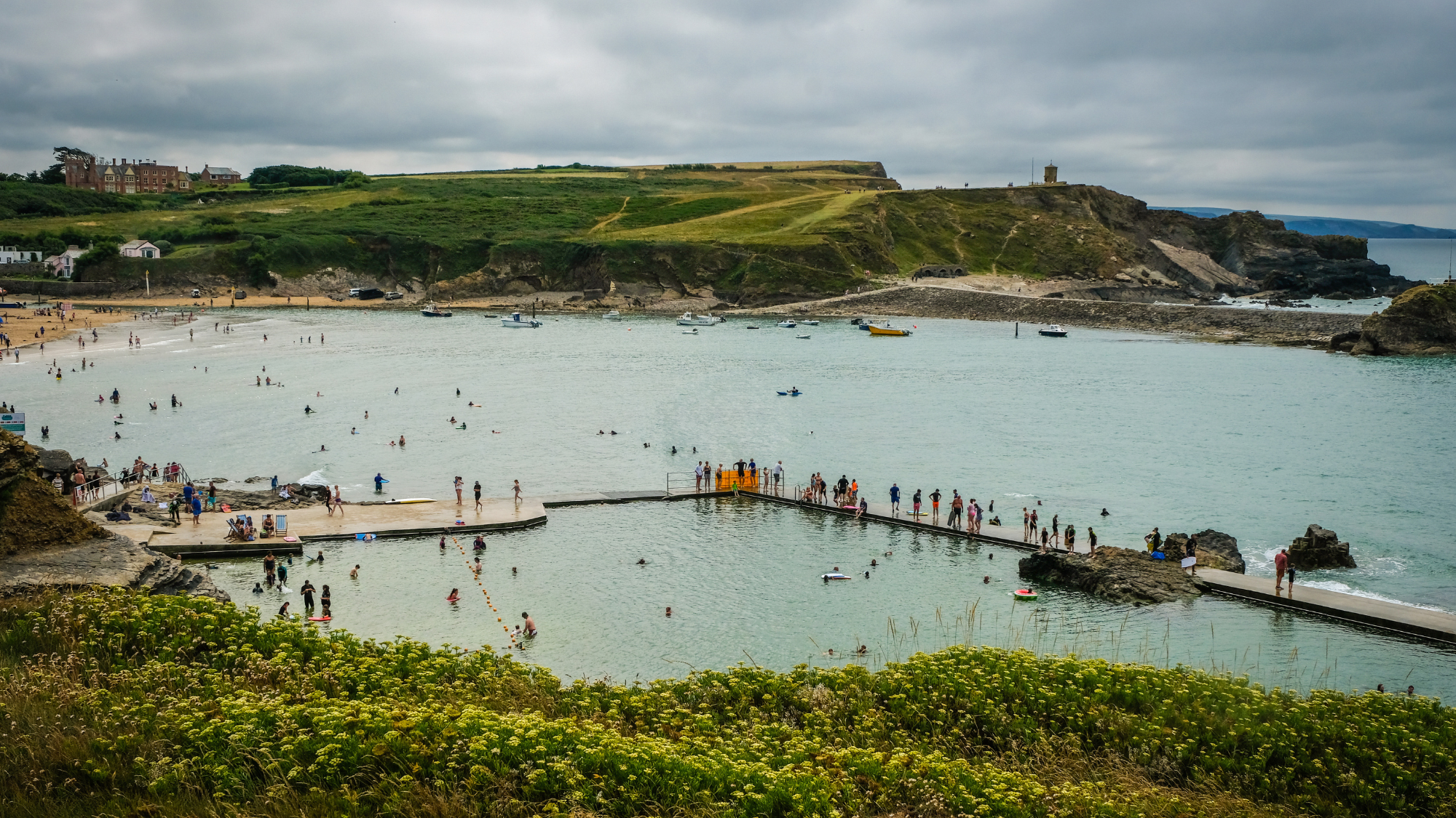 People swimming at the Bude Sea Pool in Cornwall