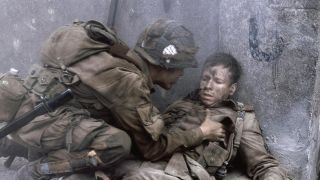 An injured Second Lieutenant Carwood Lipton (Donnie Walhberg) is tended to in the heat of battle in Band of Brothers