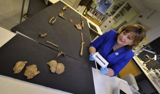 Fiona Hyslop, Cabinet Secretary for Culture and External Affairs in Ireland, looks at a belt buckle found with a skeleton that may belong to Olaf Guthfrithsson.