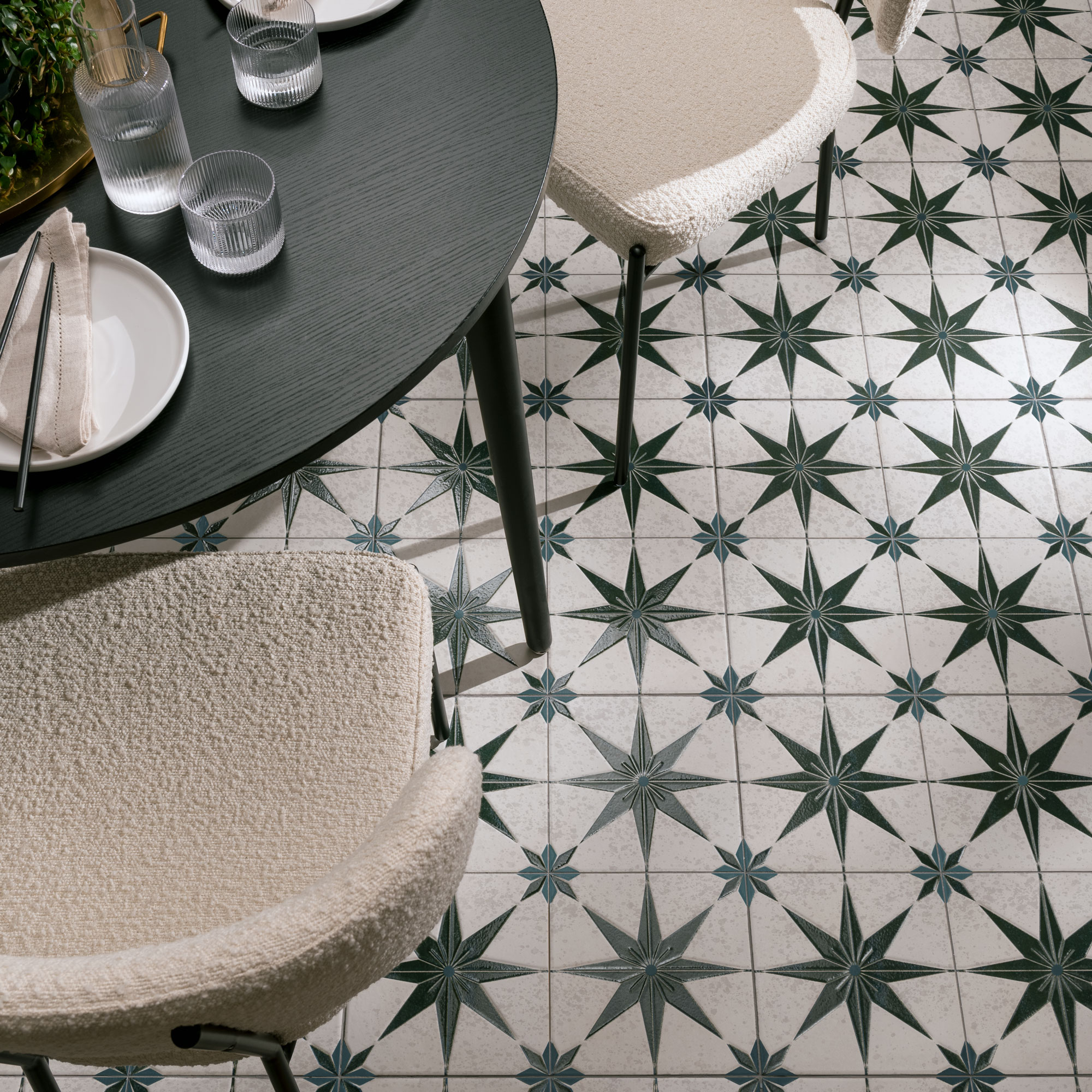 Green star tiles on a floor under a table