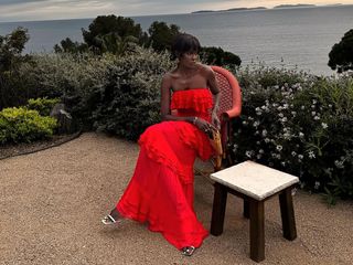 @lefevrediary in J.Crew red ruffle gown overlooking ocean