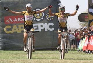 Christoph Sauser and Burry Stander of 36One-Songo-Specialized celebrate as they cross the line to win stage 4