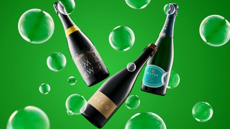 Three floating wine bottles labeled Mountfield Winery, Hugo, and Wiston, surrounded by translucent green bubbles on a green background