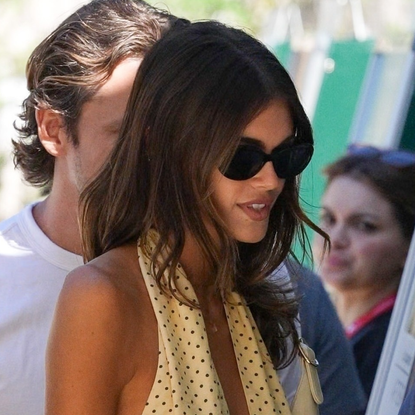Kaia Gerber wears a polka dot halter top and carries a Gucci Jackie 1961 bag