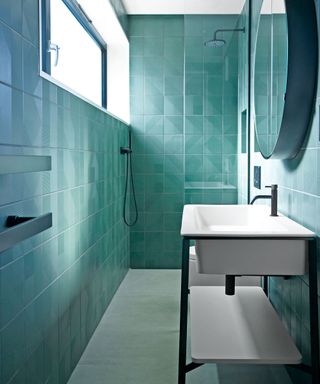 Guest bathroom with blue tiles in narrow space