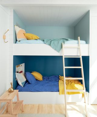 built in bunk beds in alcove with blue and yellow colours scheme, white framed beds