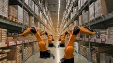 Robots with artificial intelligence stock shelves in a warehouse.