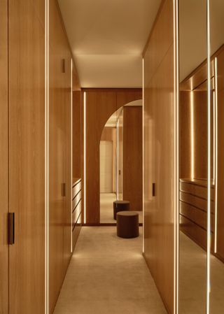 A walk in wardrobe with LED strip lights