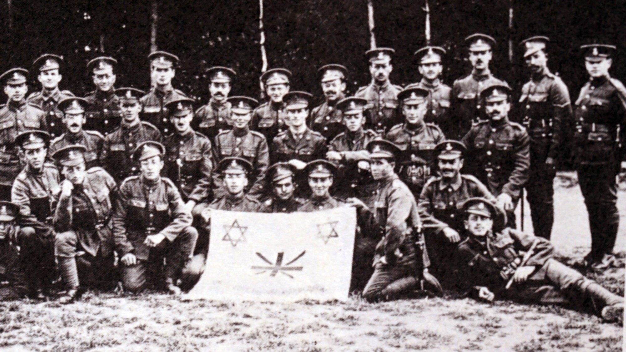 soldiers of the Jewish Legion pictured with a Jewish and British banner during World War One