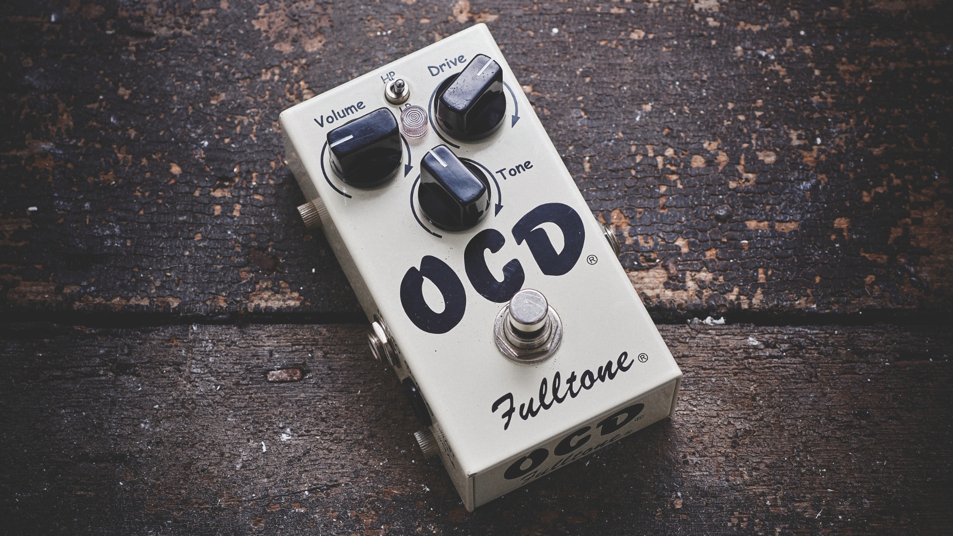 A Fulltone OCD overdrive pedal on a wooden floor