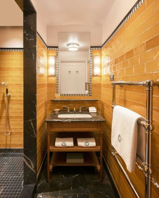 a small bathroom with horizontal wall tiles