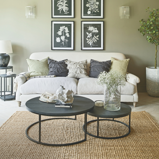 black circular coffee table with fresh flowers and white decor