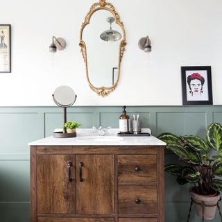 white and grey wall designed mirror on wall and wooden sideboard