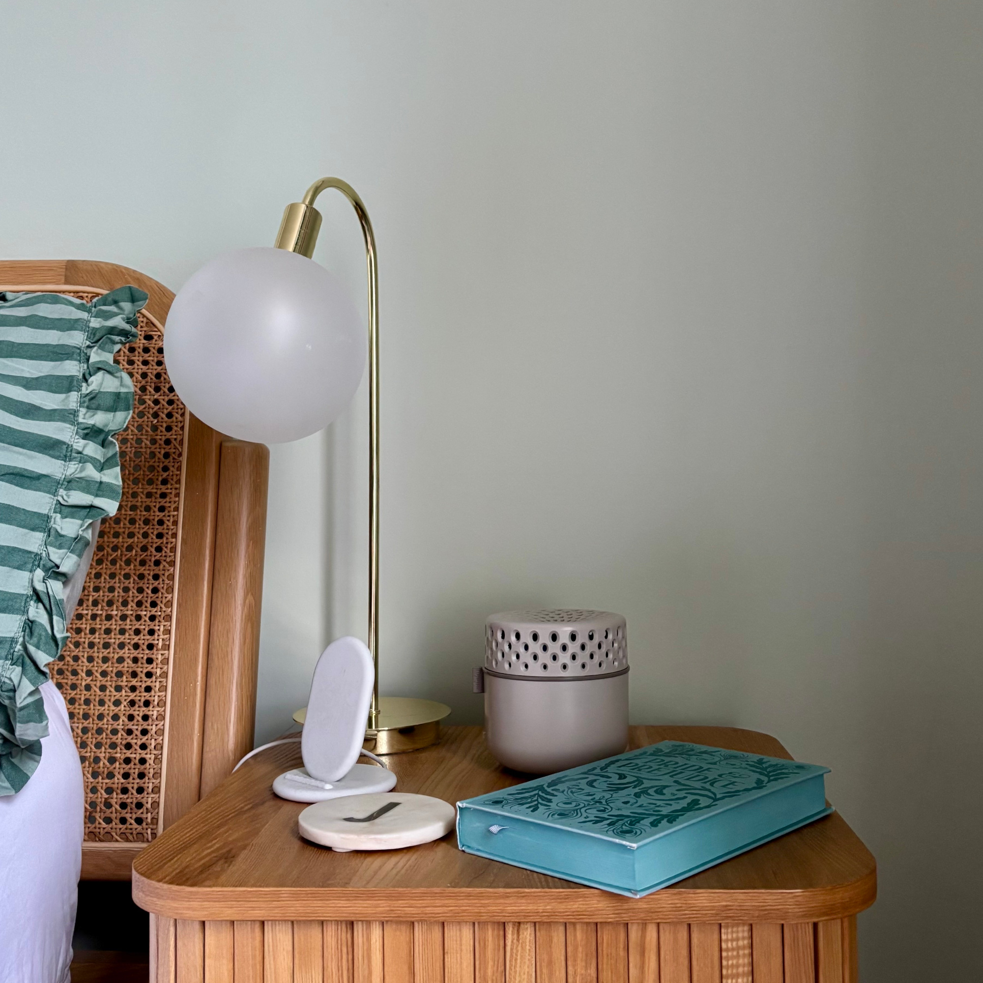 bedside table with minky damp guard book, charger and coaster