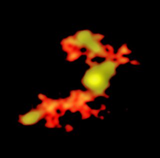 An image from the ALMA telescope in Chile showing the quasar WISE J224607.57-052635.0 using transgalactic streamers of gas and dust to feed off three nearby galaxies.