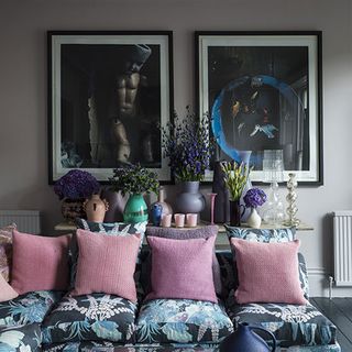 living area with sofa and cushion and artwork on wall
