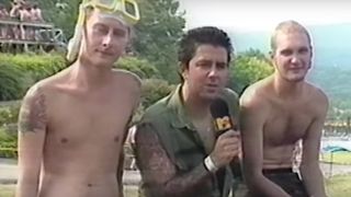 Layne Staley and Jerry Cantrell of Alice In Chains in swimming trunks, sat outdoors with MTV host Riki Rachtman