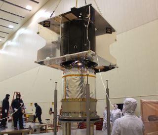 The MAVEN spacecraft's core structure is successfully lowered and attached to the hydrazine propulsion tank and boat tail assembly at Lockheed Martin's facilities in Colorado.