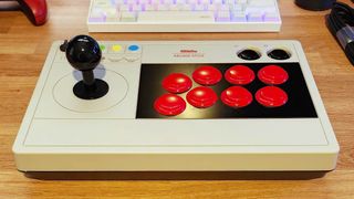 Picture of 8BitDo's Arcade Stick on a wooden benchtop.