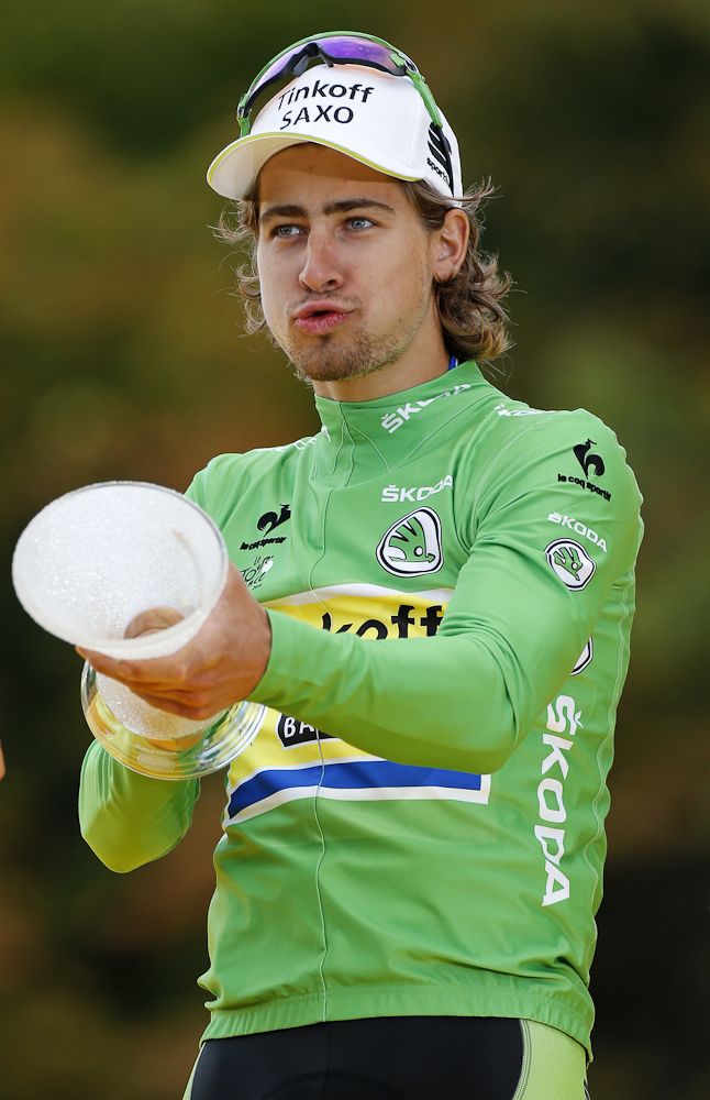 Peter Sagan clowns around with his trophy on the Tour de France's final podium.