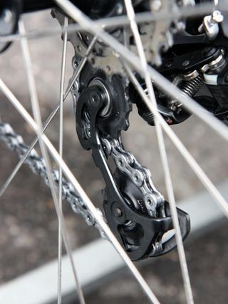 The standard carbon fiber inner pulley cage plates have been replaced with stouter aluminum ones on this HTC-Highroad Di2 rear derailleur.