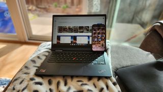 A Lenovo ThinkPad C13 Yoga Chromebook and iPhone 14 Pro