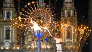 Jorge Alberto Gomes lights the Olympic flame following the opening ceremony of the Rio Games in August
