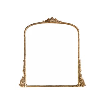 An arched gold framed mirror