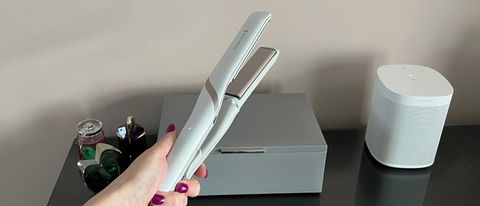 The Remington Hydraluxe Pro Straightener S9001 being held in a hand