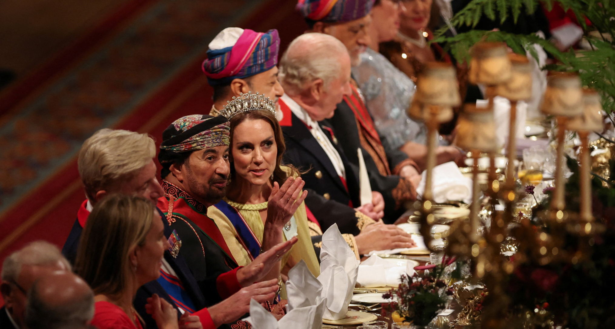 Princess Kate wearing a tiara sitting at a banquet table