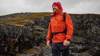 A hiker in an orange jacket
