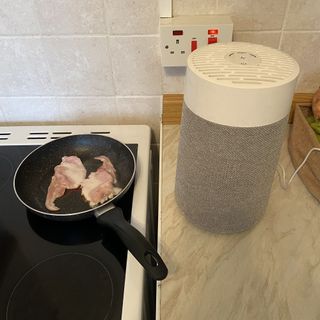 Blueair Blue Pure Mini Max Air Purifier next to bacon cooking in pan