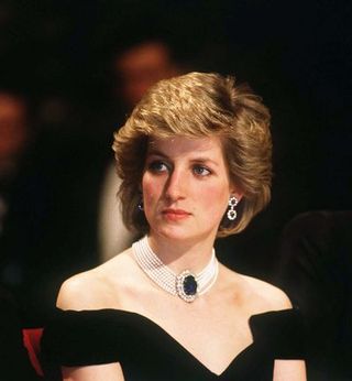 vienna, austria april 16 diana, princess of wales, wearing a midnight blue velvet, off the shoulder evening dress designed by victor edelstein, a sapphire, diamond and peal choker and diamond and sapphire earrings, attends a state banquet on april 16, 1986 in vienna, austria photo by anwar husseinwireimage