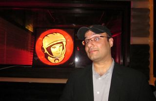SPACE.com managing editor Tariq Malik poses next to a picture of Yuri Gagarin at New York City's Yuri's Night party on April 12, 2011.