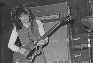 Facing: Malcolm Young performs with AC/DC at London's Marquee Club on May 12, 1976