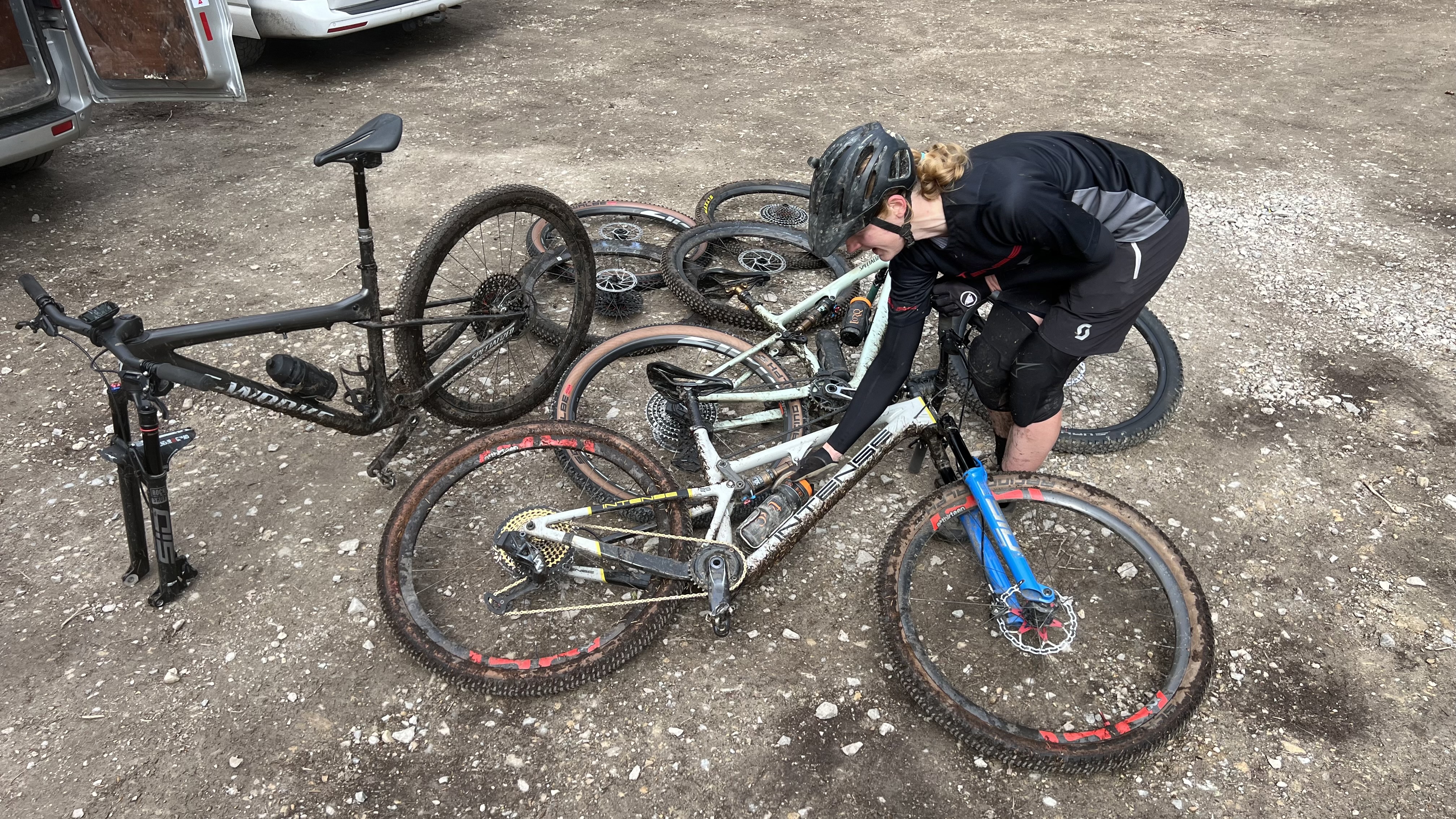 Rider picking tires from a heap of bikes and race rubber