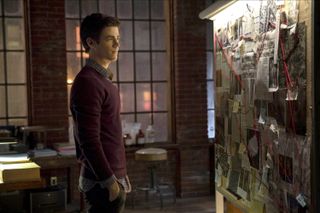 grant gustin stares at a murder board in The Flash