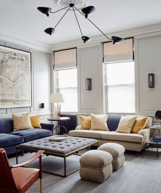Living room with grey carpet and blue and yellow cushions