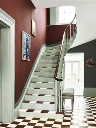 checkered painted hallway stairs in a wide Victorian entranceway
