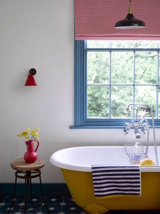 Bathroom with yellow bath and red wall lights