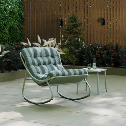 Green stripe Porto rocking chair on a shaded patio.